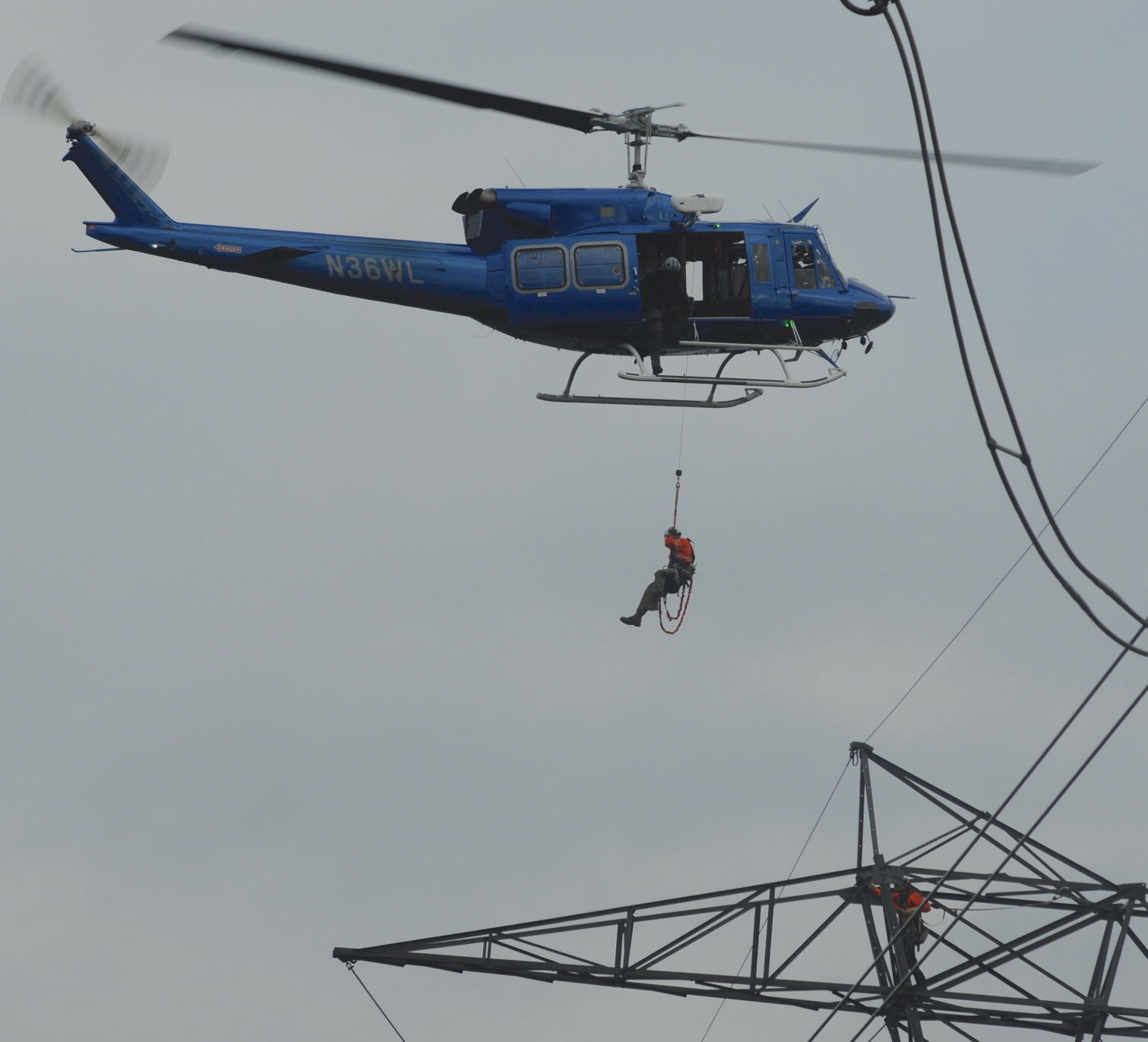 Helicopter lowers worker